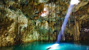 cave_light_beam_azure_lake_stalactites_stalagmites